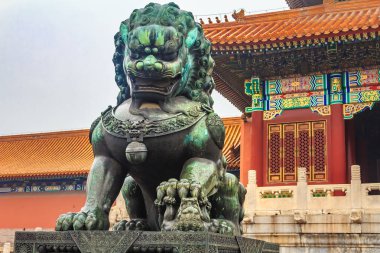 Close up of the traditional bronze female Imperial guardian lion, holding a baby in the famous Forbidden City, Beijing, China clipart