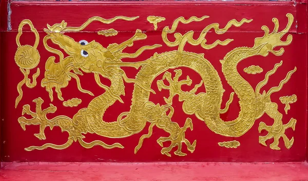 Chinise motivo dragón pintado en oro sobre fondo rojo Beijing China — Foto de Stock