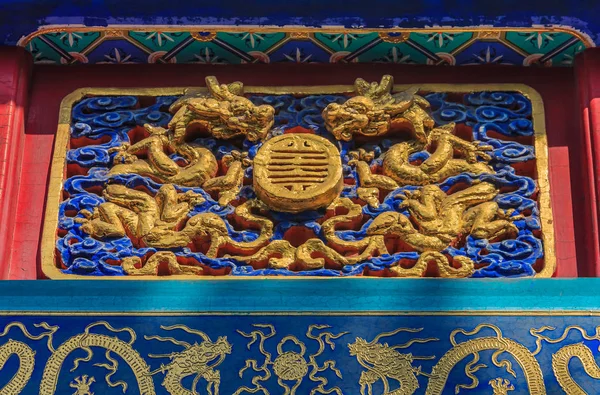 Ornate carved and painted beam and rafters with traditional Chinese golden dragon designs in Buddhist Yong'An (Temple of Everlasting Peace) in Beihai Park, Beijing, China