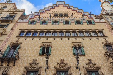 Barcelona, Spain - October 21, 2013: Facade of the famous Casa Amatller, building designed by Antoni Gaudi and one of main tourist attractions in Barcelona. clipart