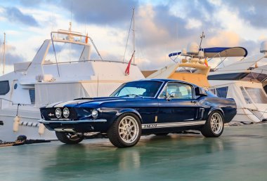 Palma de Mallorca, Spain - October 24, 2013: Classic rare American muscle car, vintage blue Ford Mustang Shelby Cobra GT-500 Fastback on a pier in Mallorca clipart