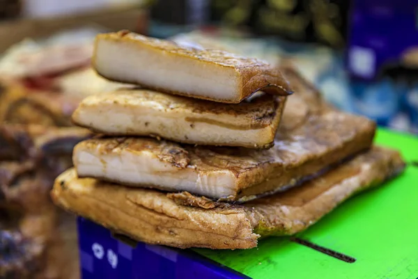 Slabs of cured and smoked pork belly fat on display at a market in Kotor Montenegro, traditional Montenegrin cuisine — Stock Photo, Image