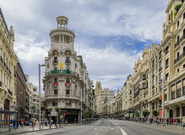 Madrid, Spain - June 5, 2017: Famous Edificio Grassy building with the Rolex sign, and beautiful buildings on Gran Via, main shopping street