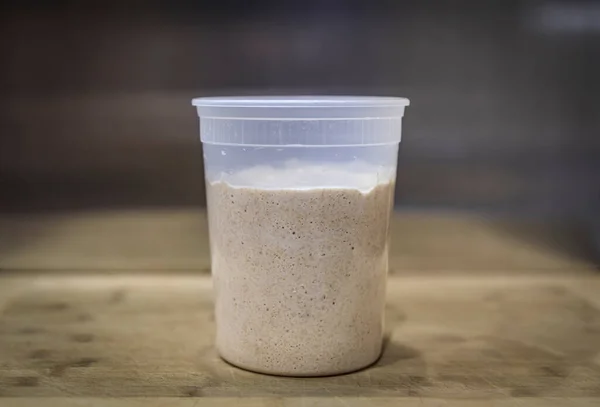 Bubbly white and wheat sourdough starter after feeding, in preparation for mixing the dough for artisanal rustic sourdough bread, photo series