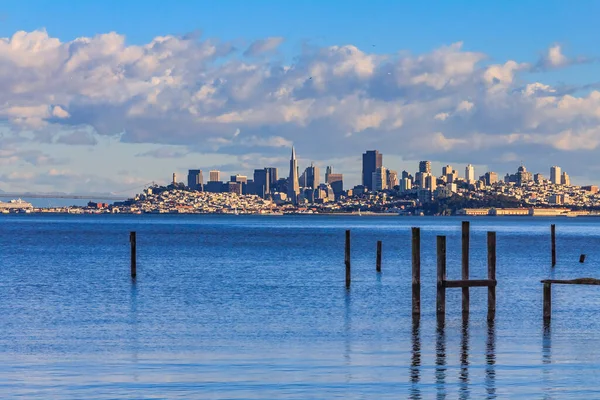 San Francisco skyline with the Bay Bridge in the background and pylons of an old pier from Sausalito circa 2011 — Stock Photo, Image