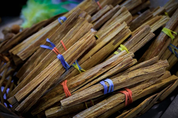 Traditional Native American Indian ocote palo santo holy sacred wood incense sticks tied in bunches on display for sale at a powwow, San Francisco