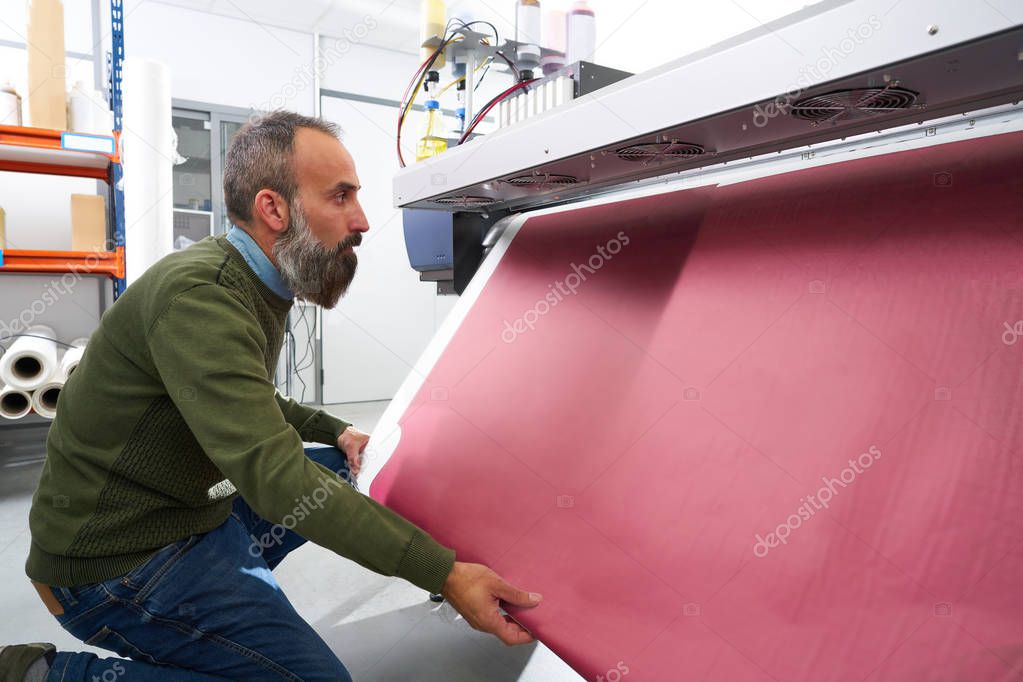 Espertise man in transfer printing industry plotter printer hipster beard