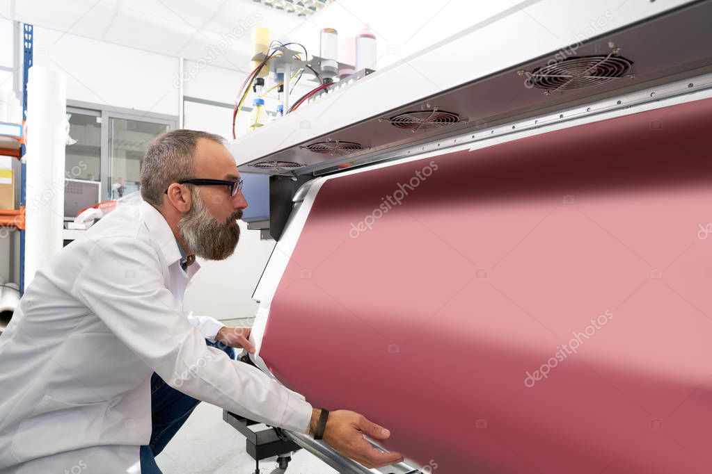Espertise man in transfer printing industry plotter printer hipster beard