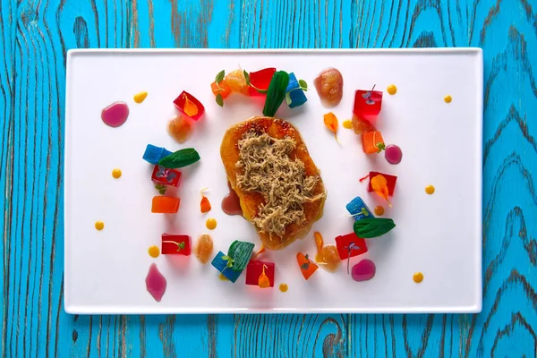 Foie slice with grated white truffle and colorful jelly decoration