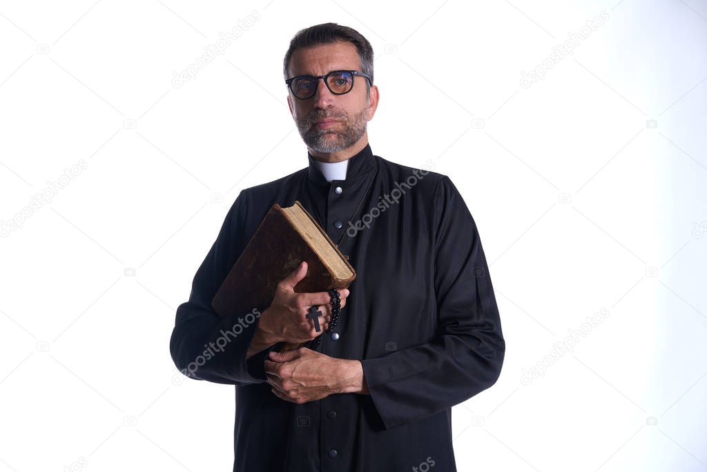 Priest portrait with Holy Bible in hands isolated on white