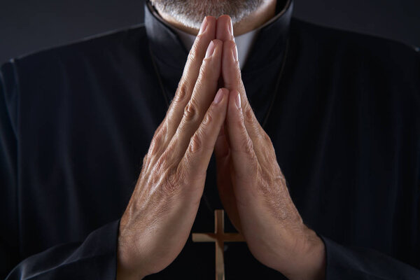 Praying hands priest portrait of male pastor