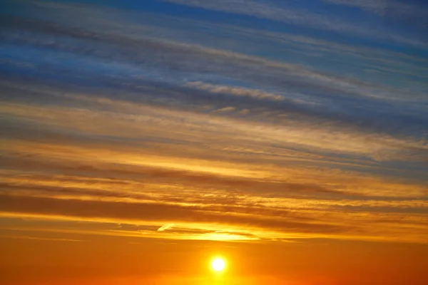 Sunset clouds sky in orange and blue background