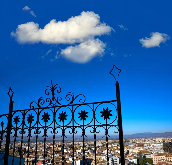 Granada skyline view from Albaicin in Andalusia Spain with iron fence