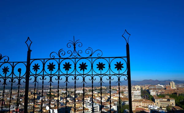 Granada skyline view from Albaicin in Andalusia Spain with iron fence