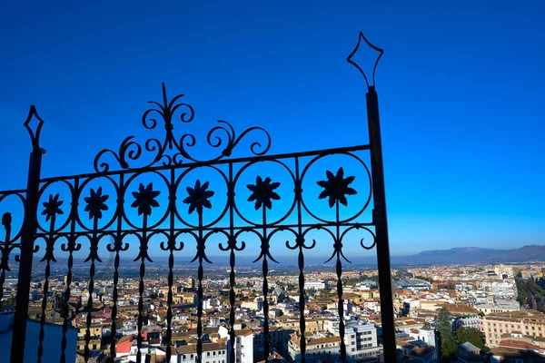 Granada skyline view from Albaicin in Andalusia Spain with iron fence