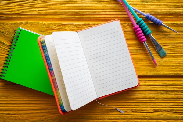 Back to school supplies notebook an brush — Stock Photo, Image