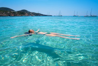 Ibiza bikini girl swimming clear water beach clipart