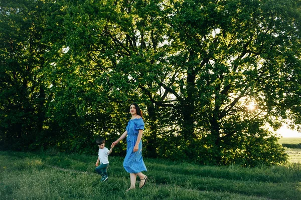 stock image Stilish mother and handsome son having fun on the nature. Happy family concept. Beauty nature scene with family outdoor lifestyle. Happy family resting together. Happiness in family life. Mothers day.