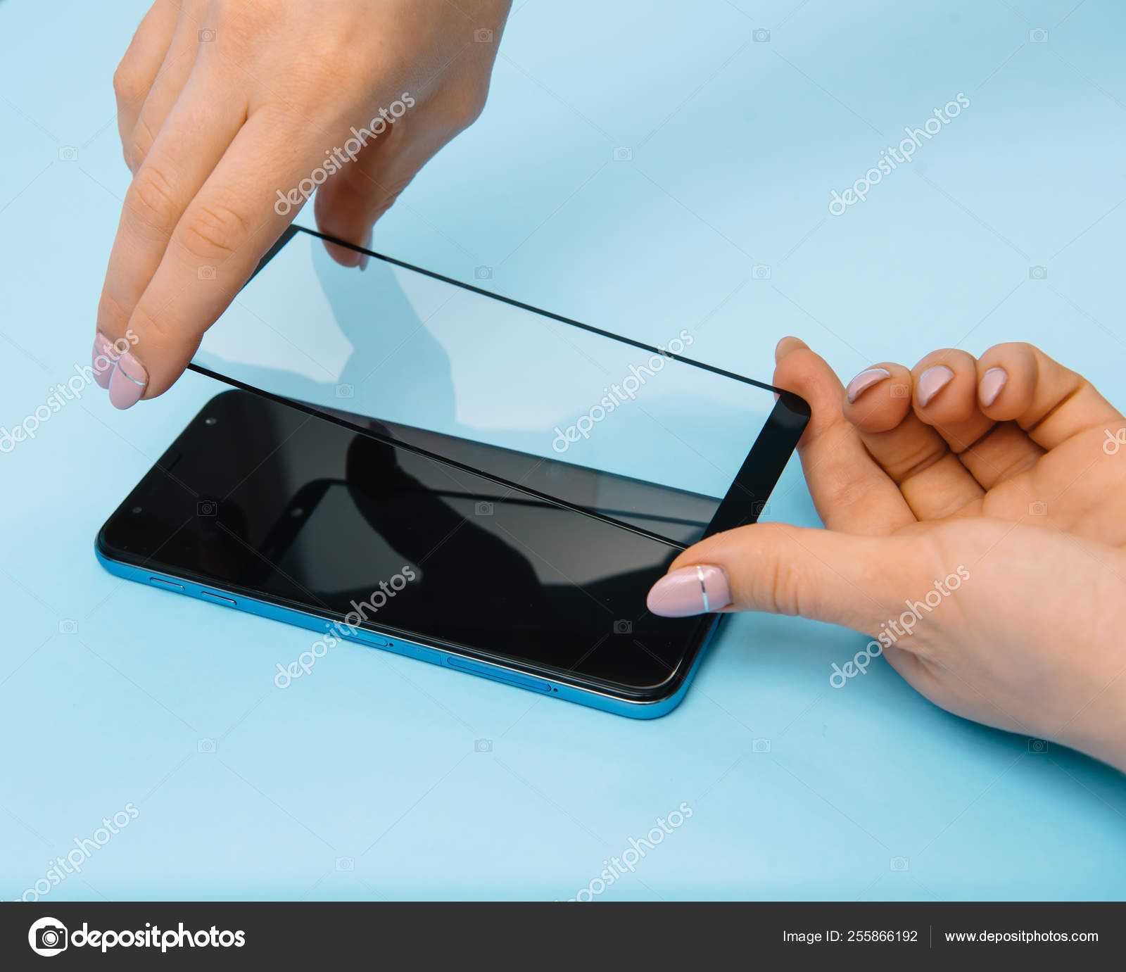 Smartphone with screen protect glass cover in hands. blue background. women  hand stick tempered glass shield or film screen cover with mobile phone.  protector concepts ideas Stock Photo by ©fotosedrik 255866192
