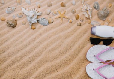 Kabukları ve havlu çerçeve ve yaz aksesuarları ile kumlu plaj üst görünümü. Kopyalama alanı ve görünür kum dokusu ile arka plan. havlu dan yapılmış sol sınır