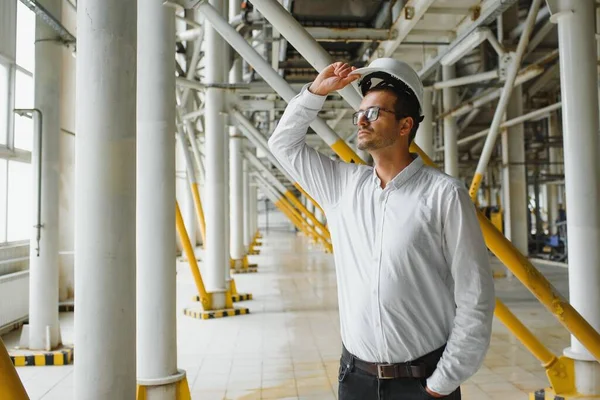 happy male industrial technician inside a factory