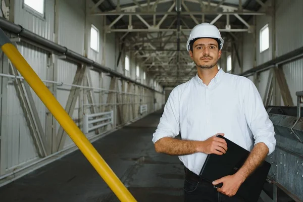 happy male industrial technician inside a factory
