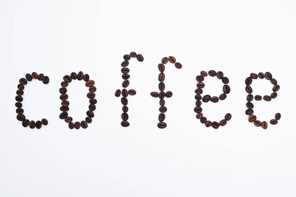 Word coffee made from coffee beans isolated on white background