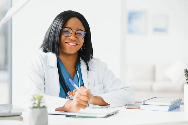 Successful black woman doctor smiling in office