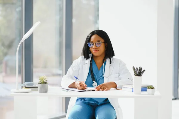 Successful black woman doctor smiling in office