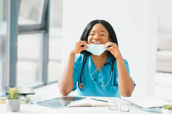 Young attractive african doctor with face mask