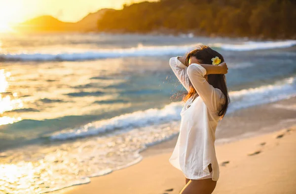 Mujer libre disfruta de la brisa del océano al atardecer — Foto de Stock