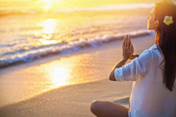 Woman Practicing Lotus Pose on Beach 