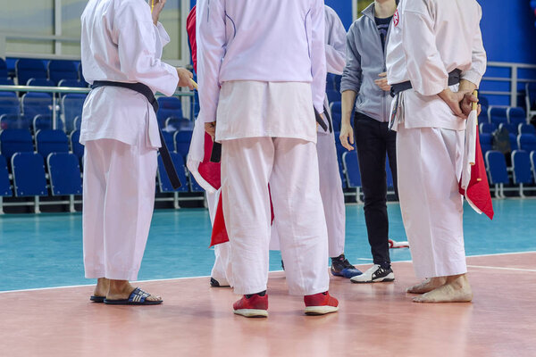 Competitions karatekas. Young karateka at the competition. Karate techniques.