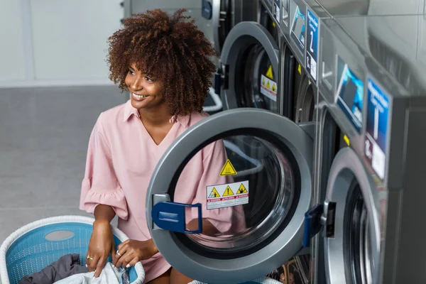 Young black African American woman washing her clothes in a auto — Stock Photo, Image