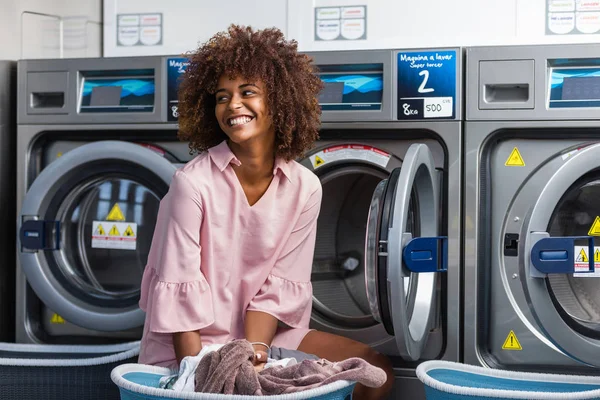 Young black African American woman washing her clothes in a auto — Stock Photo, Image