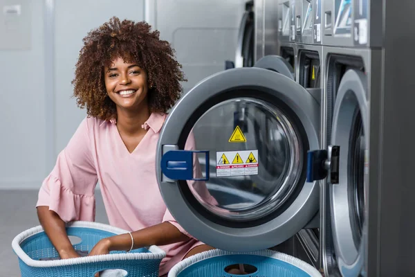 Young black African American woman washing her clothes in a auto — Stock Photo, Image