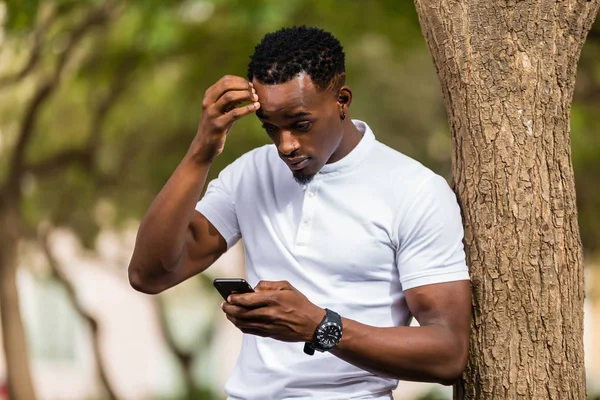 Retrato al aire libre de un joven negro afroamericano mensajes de texto —  Fotos de Stock