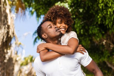 Outdoor protrait of black african american couple - Guy carrying clipart