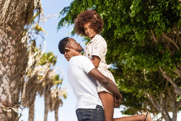 Outdoor protrait of black african american couple - Guy carrying — Stock Photo, Image