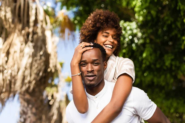 Outdoor protrait of black african american couple - Guy carrying — Stock Photo, Image