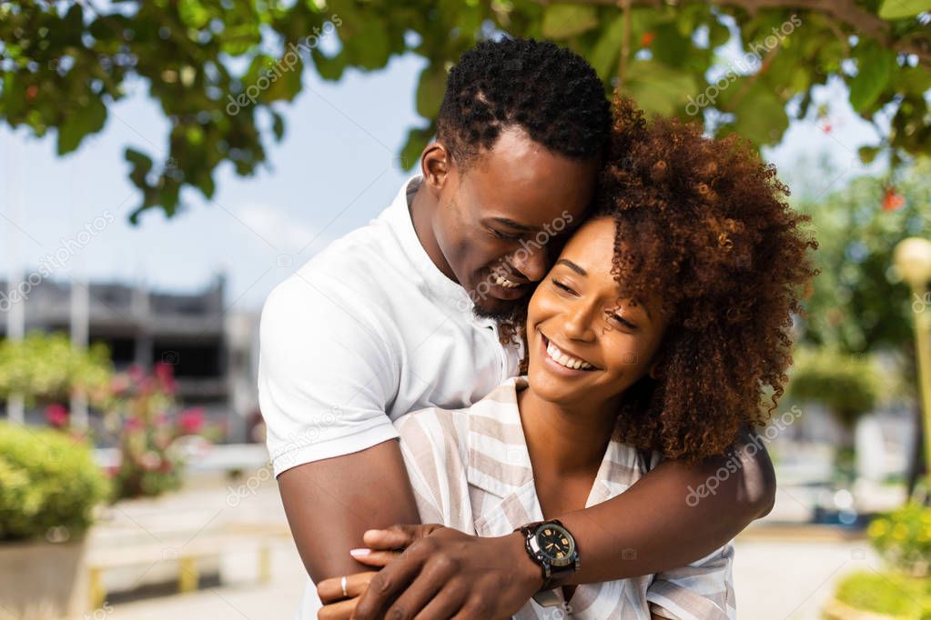 Outdoor protrait of black african american couple embracing each