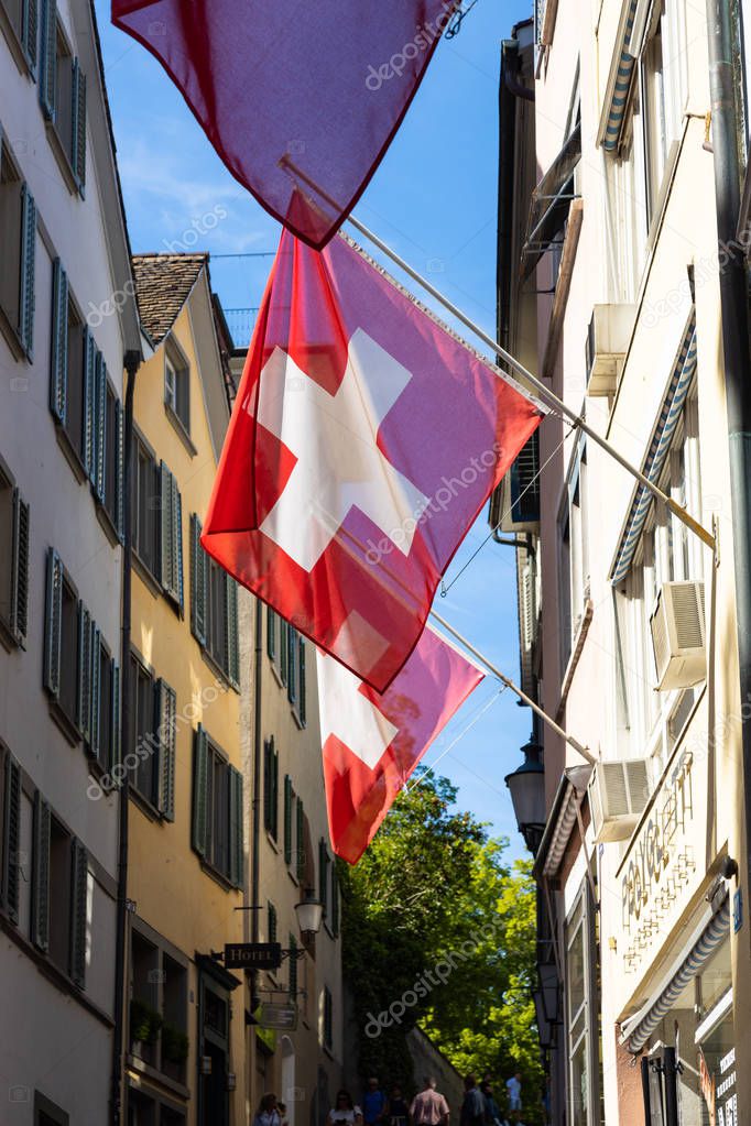 Swiss flags floating in the streets of the old town of Zurich ci