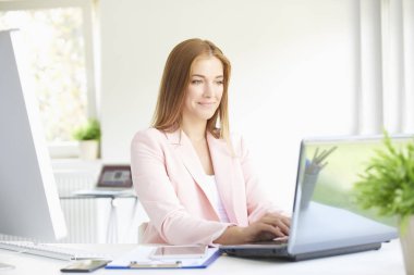 Modern ofis dizüstü bilgisayar üzerinde çalışan bir güzel genç satış müdürü iş kadını vurdu. 