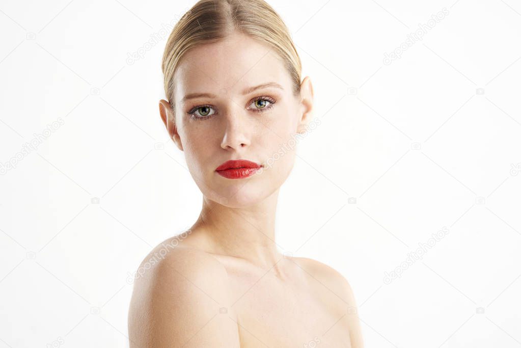 Portrait shot of beautiful young woman wearing red lipstick and looking at camera. Isolated on white background. 