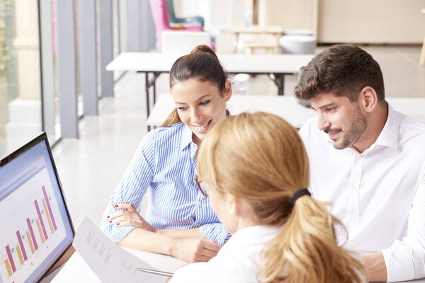 Investment advisor businesswoman and her clients analyze financi