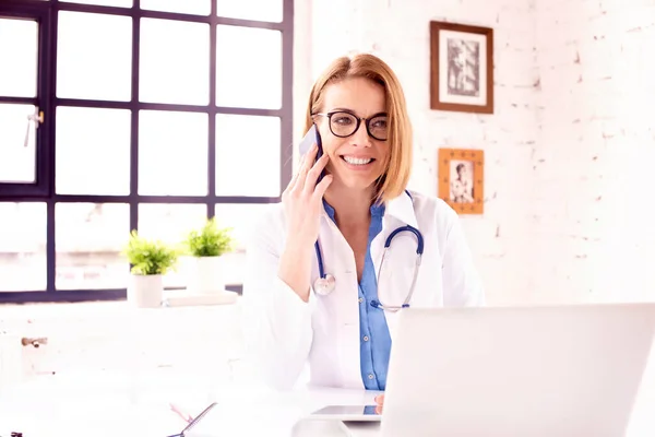 Shot Mature Female Doctor Talking Somebody Her Mobile Phone While — Stock Photo, Image