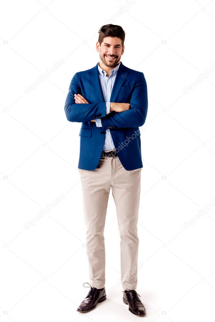 Full length shot of happy businessman wearing business casual clothes while standing with arms crossed at isolated white background.