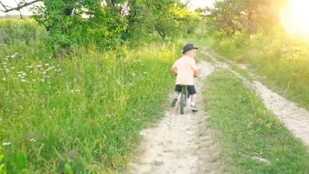 Little boy riding a bicycle without pedals — Stock Video