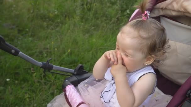 Маленькая девочка в коляске — стоковое видео