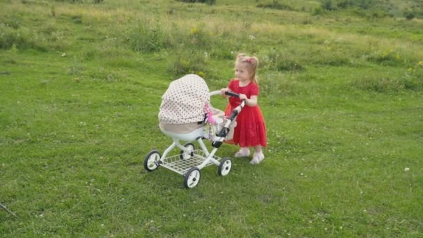 Bir bebek arabası ile küçük kız — Stok video